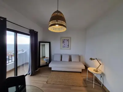a living room with a white couch and a lamp at The Albufeira Concierge - Prime Beach Center L3 in Albufeira
