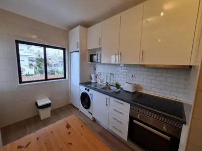 a kitchen with a sink and a washing machine at The Albufeira Concierge - Prime Beach Center L3 in Albufeira