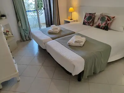 a bedroom with two beds with towels on them at Albufeira Balaia Golf Vilage 4 With Pool by Homing in Albufeira