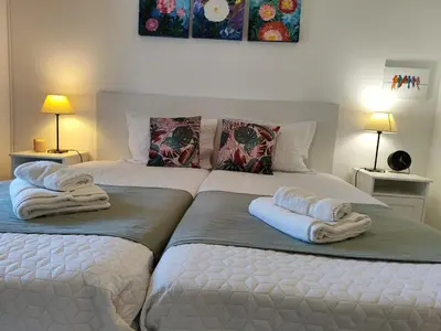 two beds sitting next to each other in a bedroom at Albufeira Balaia Golf Vilage 4 With Pool by Homing in Albufeira
