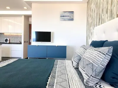 a bedroom with a bed and a tv on a wall at Lagoon Bleue in Albufeira