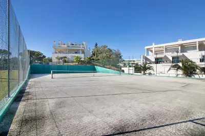 a tennis court in front of a house at Algarve Paraíso - Monte da Balaia in Olhos de Água