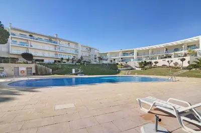 a tennis court in front of a building at Algarve Paraíso - Monte da Balaia in Olhos de Água