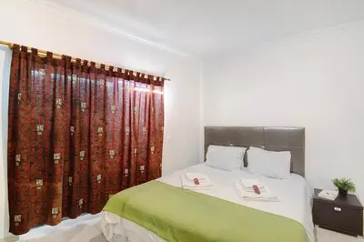 a bedroom with a bed and a large mirror at Algarve Paraíso - Monte da Balaia in Olhos de Água