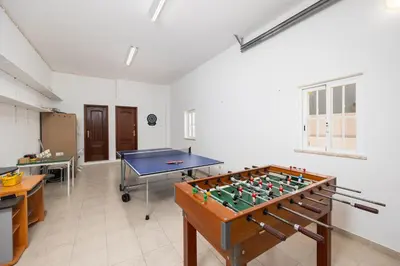 a villa with a swimming pool in front of a house at Villa Marlene in Guia