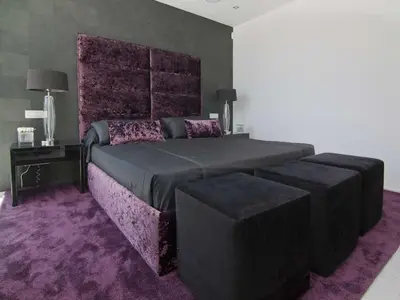 a bedroom with a large bed and a purple carpet at Phenomenal Algarve Villa Villa Flowerscape 4 Bedrooms Steam Room & Home in Almancil