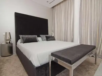 a bedroom with a large white bed and a bench at Phenomenal Algarve Villa Villa Flowerscape 4 Bedrooms Steam Room & Home in Almancil