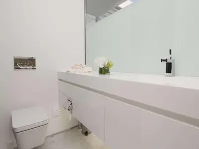 a white bathroom with a toilet and a mirror at Phenomenal Algarve Villa Villa Flowerscape 4 Bedrooms Steam Room & Home in Almancil