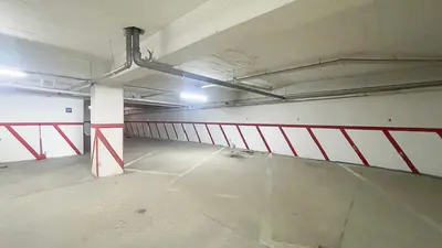 an empty parking garage with a red and white railing at Quarteira Frente Praia II by HomeSlow Rentals in Quarteira