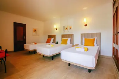 a room with two beds with orange and white pillows at Villa Punta Cana by Algarve Vacation in Albufeira