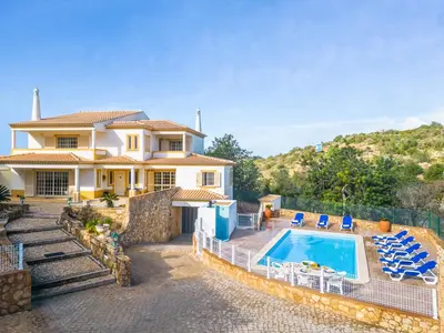 a villa with a swimming pool and a house at Villa Punta Cana by Algarve Vacation in Albufeira