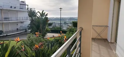 a balcony with plants and a view of a city at Encosta Da Orada in Albufeira