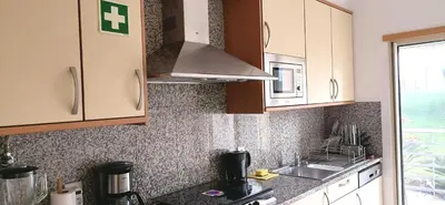 a kitchen with a sink and a stove top oven at Encosta Da Orada in Albufeira