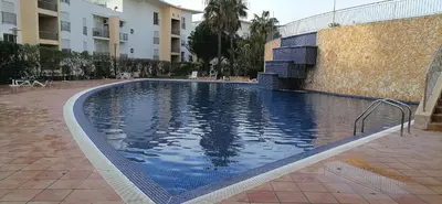 a large swimming pool next to a building at Encosta Da Orada in Albufeira
