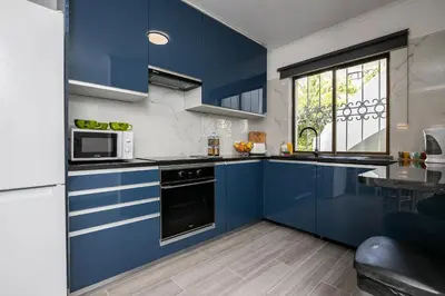 a kitchen with blue cabinets and a window at Apartment in São Rafael Albufeira Beach Resort in Albufeira