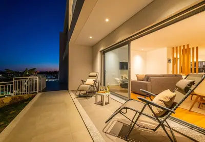 a living room with a couch and chairs on a balcony at Townhouse Varadero by Algarve Vacation in Albufeira
