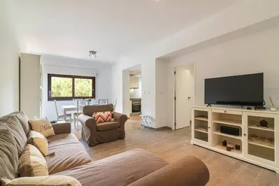 a living room with a couch and a flat screen tv at Vilamoura M.M. Sunrise T2 in Vilamoura