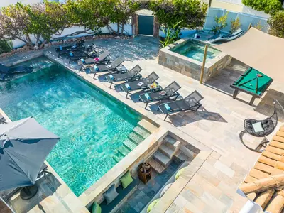 an overhead view of a swimming pool with chairs and an umbrella at Villa Shangri-La by Algarve Vacation in Albufeira