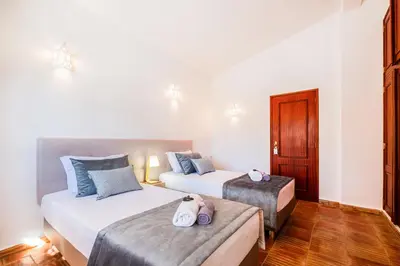 a hotel room with two beds with towels on them at Villa Shangri-La by Algarve Vacation in Albufeira
