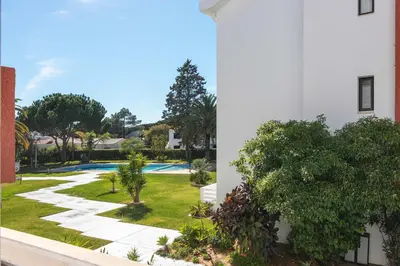 a view of the garden from the balcony of a house at Vilamoura M.M. Holidays T2 in Vilamoura