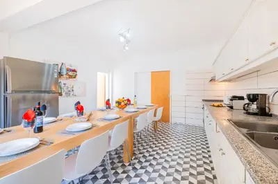 a kitchen with a long table with white counter tops at Villa Isla Bella by Algarve Vacation in Albufeira