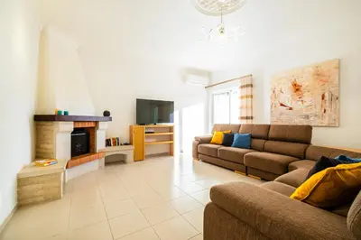 a living room with two couches and a fireplace at Villa Isla Bella by Algarve Vacation in Albufeira