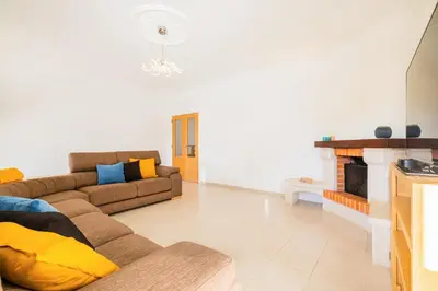 a living room with a couch and a fireplace at Villa Isla Bella by Algarve Vacation in Albufeira