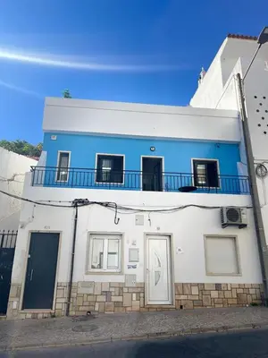 a blue and white building with a balcony at Boutique Style Town House in Albufeira