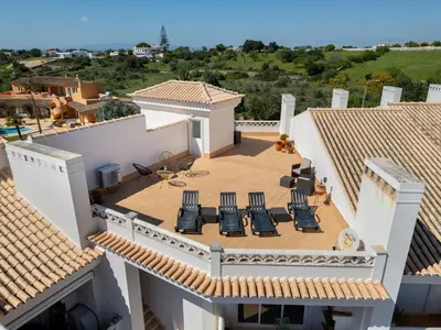 a table and chairs on a balcony with a pool at Apartment Aguia M T2 - VIP Properties by Interhome in Albufeira
