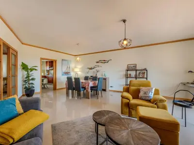 a living room with a yellow couch and a table at Apartment Aguia M T2 - VIP Properties by Interhome in Albufeira