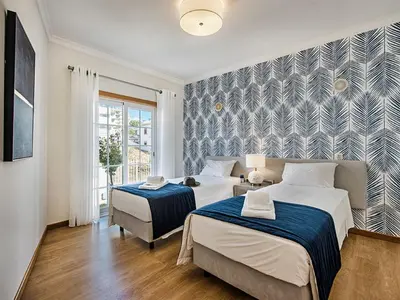 a bedroom with a bed and a black and white wallpaper at Holiday Home Demi - VIP Properties by Interhome in Albufeira