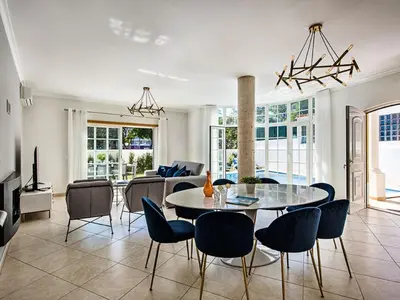 a living room with a table and chairs at Holiday Home Demi - VIP Properties by Interhome in Albufeira
