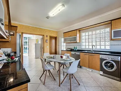 a kitchen and dining room with a table and chairs at Holiday Home Demi - VIP Properties by Interhome in Albufeira