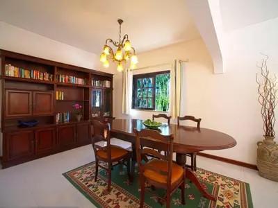 a dining room with a wooden table and chairs at Villa Maria by Interhome in Albufeira