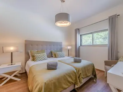 a kitchen with white cabinets and a stove top oven at Apartment Jardins Marina T2 - VIP Properties by Interhome in Albufeira