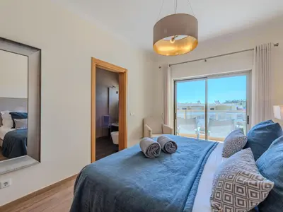 a living room with a couch and a table at Apartment Jardins Marina T2 - VIP Properties by Interhome in Albufeira