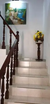 a staircase with a vase of flowers on the wall at Ria Formosa Pineview in Faro