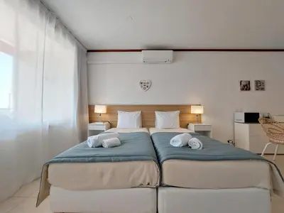 a bedroom with a bed with two pillows on it at Loule Turtle by SAPvillas in Vilamoura
