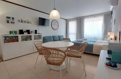 a living room with a bed and a table and chairs at Loule Turtle by SAPvillas in Vilamoura