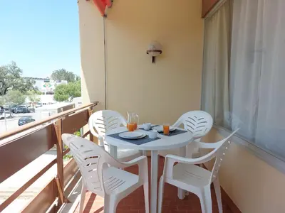 a white table and chairs on a balcony at Loule Turtle by SAPvillas in Vilamoura