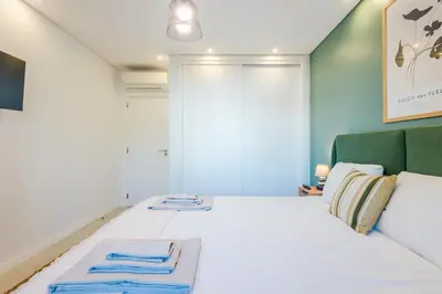 a bedroom with a bed with two towels on it at Balaia apartment at Albufeira in Albufeira