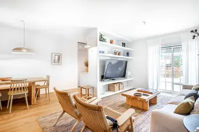 a living room with a couch and a table at BeGuest Falesia Beach & Garden in Albufeira