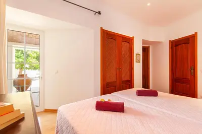 a bedroom with a bed with a red box on it at Villa Las Palmas by Algarve Vacation in Albufeira