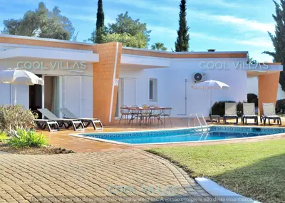 a villa with a swimming pool and a house at Orquidea Senses - 6 Pax - Sea View in Albufeira