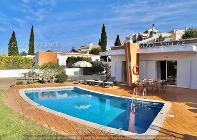 a swimming pool in front of a house at Orquidea Senses - 6 Pax - Sea View in Albufeira