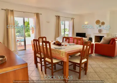 a kitchen and living room with a table and chairs at Orquidea Senses - 6 Pax - Sea View in Albufeira