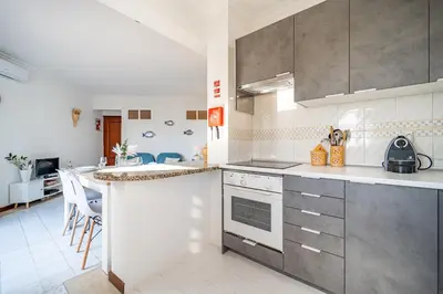 a kitchen with a stove and a counter top at Vilamoura Sea View in Vilamoura
