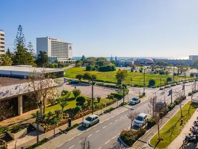 a city street with cars parked on the road at Vilamoura Sea View in Vilamoura