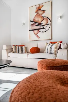 a living room with a white couch and orange pillows at Apart Ocean View in Albufeira