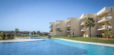 a swimming pool in front of a building at Sir Anthony Luxury in Albufeira